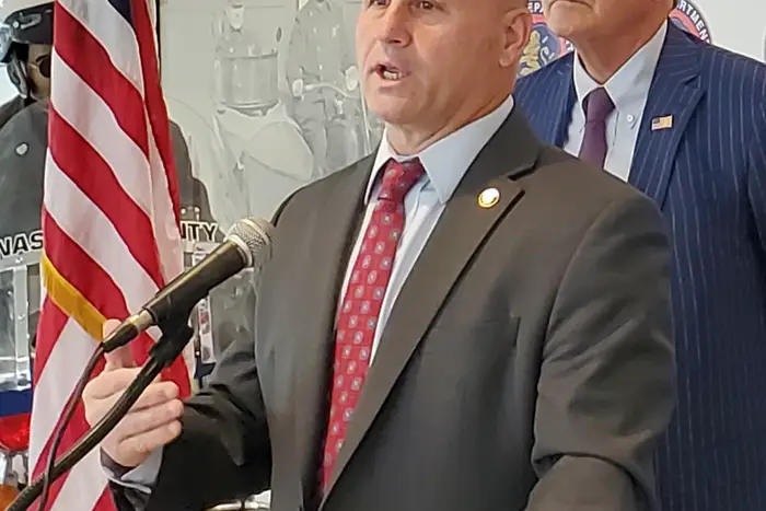 Nassau County Police Commissioner Patrick Ryder speaks as Bruce Blakeman, the newly sworn-in county executive, looks on. (Charles Lane/WSHU)